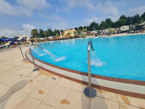 a swimming pool with a water slide in it at Les sables du midi in Valras-Plage