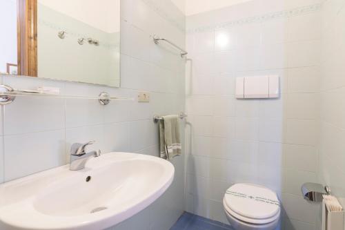 a white bathroom with a sink and a toilet at Foresteria Valdese di Firenze in Florence