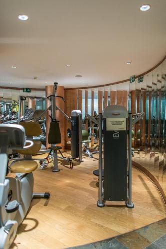 a gym with several treadmills and exercise bikes at Lux Garden Hotel in Azuga