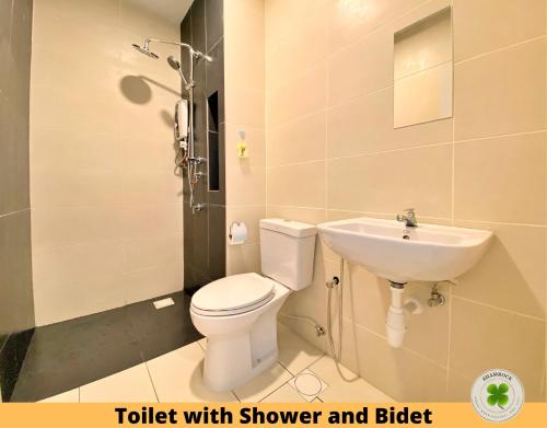 a bathroom with a sink and a toilet with shower and bidet at Pacific Tower Petaling Jaya By Shamrock in Petaling Jaya