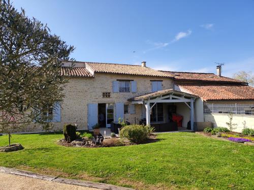a white brick house with a large yard at Les Chenets in Chenay