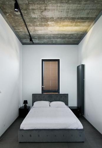 a bedroom with a bed in a white room at Apartamenty Dworcowa 60 in Gliwice