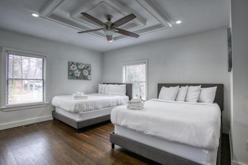 a bedroom with two beds and a ceiling fan at Buckhead Atlanta Chateaumessage For Spring Dis! in Atlanta