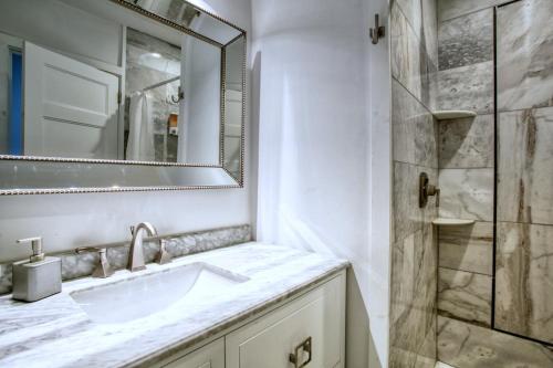 a white bathroom with a sink and a shower at Buckhead Atlanta Chateaumessage For Spring Dis! in Atlanta