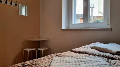 a bedroom with two beds and a window at Hostel Alieti in Izola
