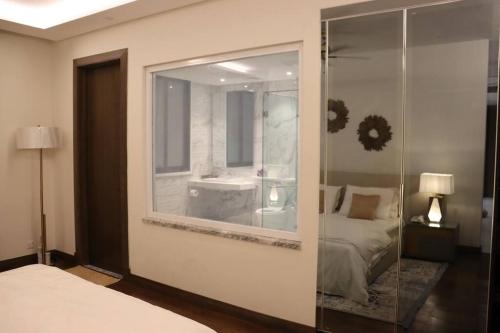 a bedroom with a large mirror and a bed at Living Sensory 1-bed rental apartment unit with Pool in Lahore