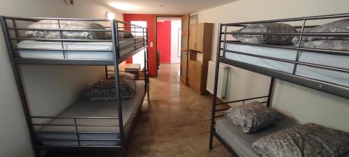 a hallway with three bunk beds in a room at La Diligence 
