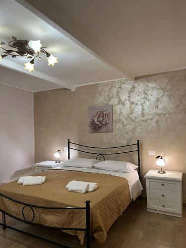 a bedroom with a large bed with two lamps on it at Martinahouse in Vico nel Lazio