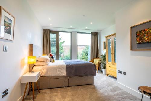 a bedroom with a bed and a large window at Apartment 304 @ Ryedale House in York