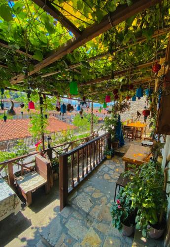 a patio with a table and chairs and plants at Avcıoğlu Konak Otel in Safranbolu