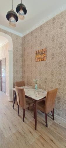 a dining room with a table and chairs at Guest House Tamta in Stepantsminda