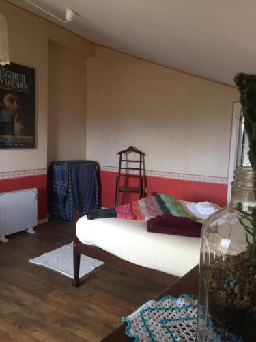 a room with a bed and a ladder in it at Casa do Castelo de Celorico in Celorico da Beira