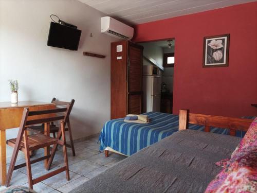 a bedroom with a bed and a desk and a table at Terrazas de Aguas Dulces in Aguas Dulces
