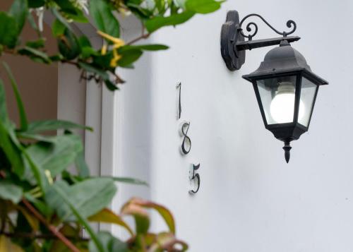 a light on the side of a wall with a sign at Lima 18 Boutique in Lima