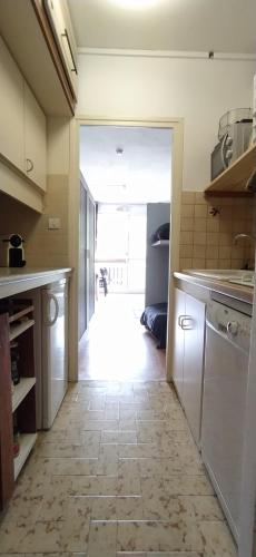 a kitchen with a door leading to a hallway at Superdevoluy appart 7ème étage sud Aurouze in Superdevoluy