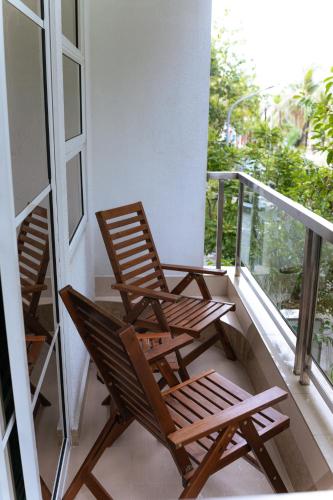 two rocking chairs sitting on a balcony at Beach Breeze and Spa in Hulhumale
