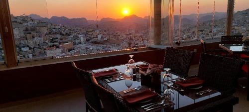 a room with chairs and a view of a city at Petra Elite Hotel in Wadi Musa