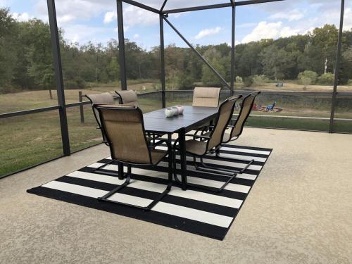 a dining table and chairs on a patio at The Retreat at Hempstead in Hempstead