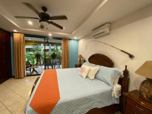 a bedroom with a bed and a ceiling fan at Monte Carlo Luxury Condominiums in Jacó