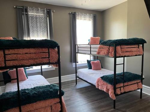 a room with four bunk beds and a window at Old North Shanty in Saint Louis