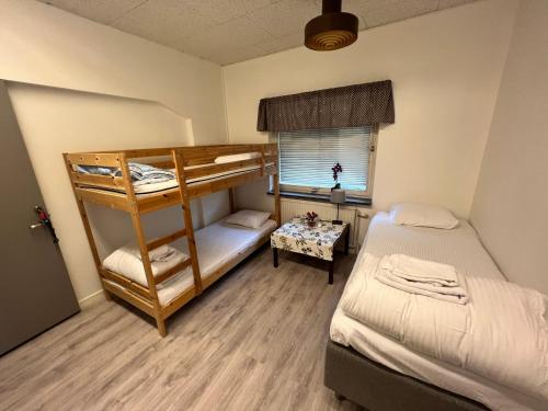 a bedroom with two bunk beds and a window at Vandrarhem Oden in Odensbacken