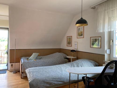 a small bedroom with two beds and a table at Vintage Apartment Wolf 