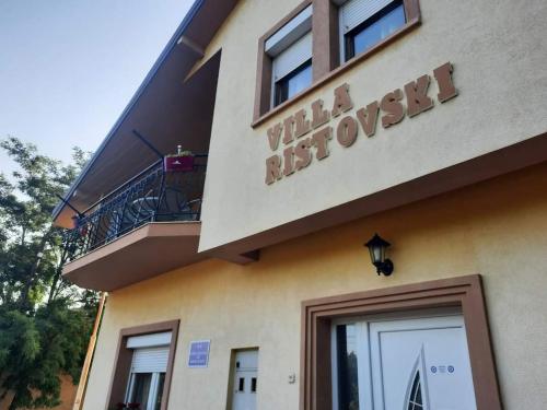 a building with a sign on the side of it at Villa Ristovski in Ohrid