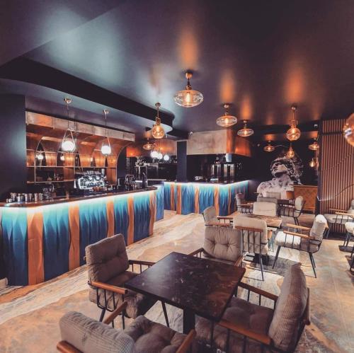 a room with tables and chairs and a bar at SOLMAR Studio Sea View in Năvodari