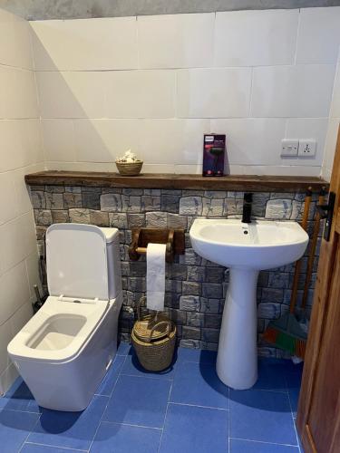 a bathroom with a toilet and a sink at The View of Zanzibar in Michamvi
