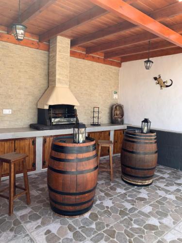 a kitchen with two wine barrels and a stove at LA CAÑADA in Tiscamanita