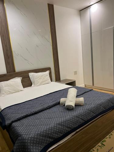 a bedroom with a bed with two towels on it at Hotel,Căn Hộ Mũi Né Sea link in Phan Thiet