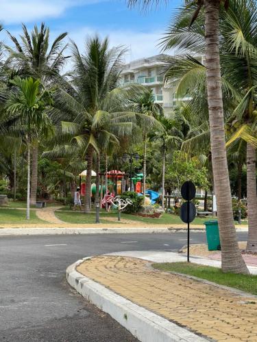an empty street with palm trees and a playground at Hotel,Căn Hộ Mũi Né Sea link in Phan Thiet