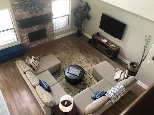a living room with a couch and a tv at The Retreat at Hempstead in Hempstead