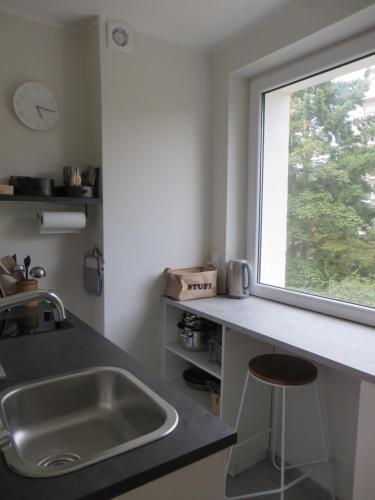 a kitchen with a sink and a window at Apartament Tade in Sopot