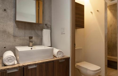 a bathroom with a sink and a toilet at El Doce by HomiRent in Laborcillas
