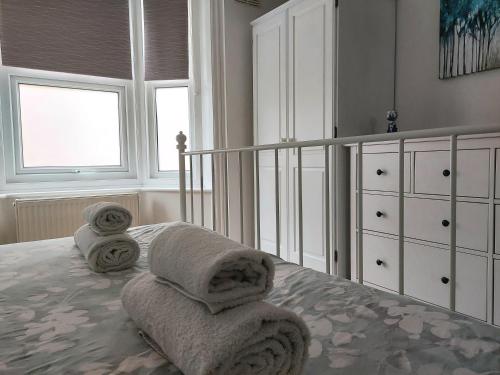 a bedroom with a bed with towels on it at Cosy Central Canterbury - Modern Victorian in Kent