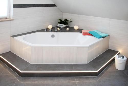 a large white bath tub in a bathroom at Ostseebrise in Brenkenhagen