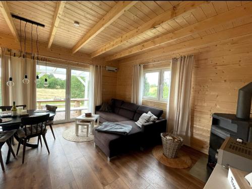 a living room with a couch and a table at Sunset House in Sulęczyno