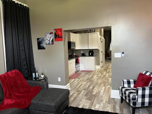 a living room with a couch and a kitchen at Old North Shanty in Saint Louis