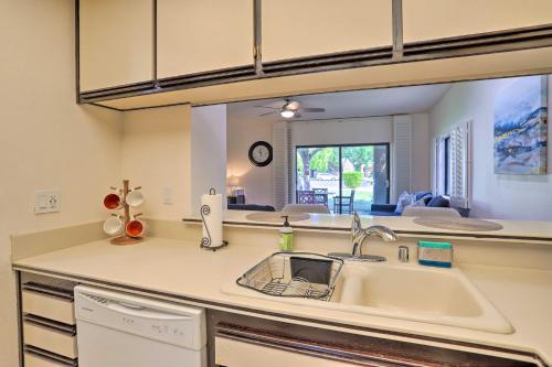 a kitchen with a sink and a large mirror at Access to 33 Pools Cathedral City Condo with Patio in Cathedral City