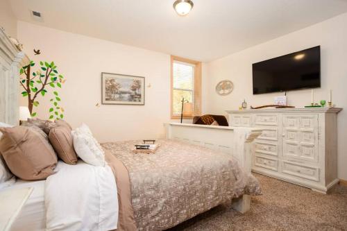 a bedroom with a bed and a flat screen tv at Woodland Legacy-Escape to unwind in Mount Vernon
