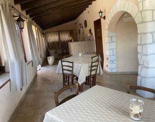 a dining room with tables and chairs in a building at Le Zarafe in Caltabellotta