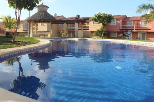 a large swimming pool in front of a house at Luxury Home Ixtapa Balcony Pool BBQ AA WIFI 250mbs! in Ixtapa