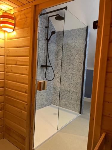 a shower in a room with a glass door at Rooftop terrace suite in Heist-op-den-Berg