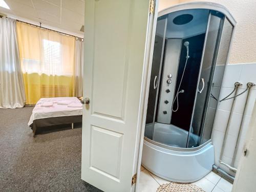 a bathroom with a shower with a glass door at Mini Hotel near Arena City in Kyiv