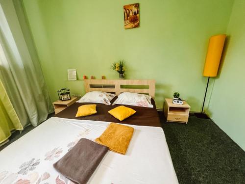 a bedroom with a bed with two towels on it at Mini Hotel near Arena City in Kyiv