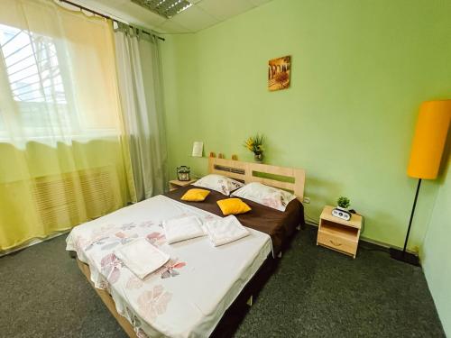 a bedroom with two beds and a window at Mini Hotel near Arena City in Kyiv