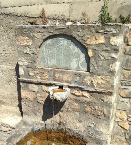 a stone wall with a bird house on it at Rapsani Panorama Villa in Rapsáni