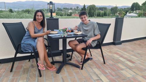 a man and a woman sitting at a table at B&B Finca la Yuca "Un paraíso en Ontinyent" in Ontinyent
