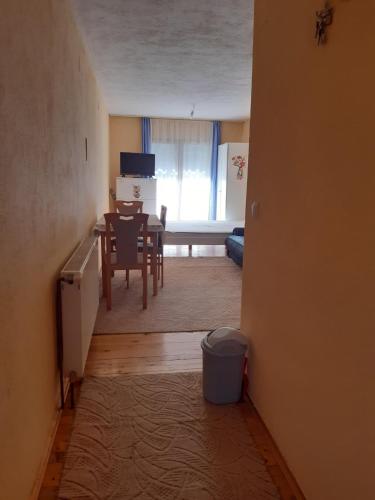 a kitchen and dining room with a table and chairs at Apartman Aurelia in Bihać